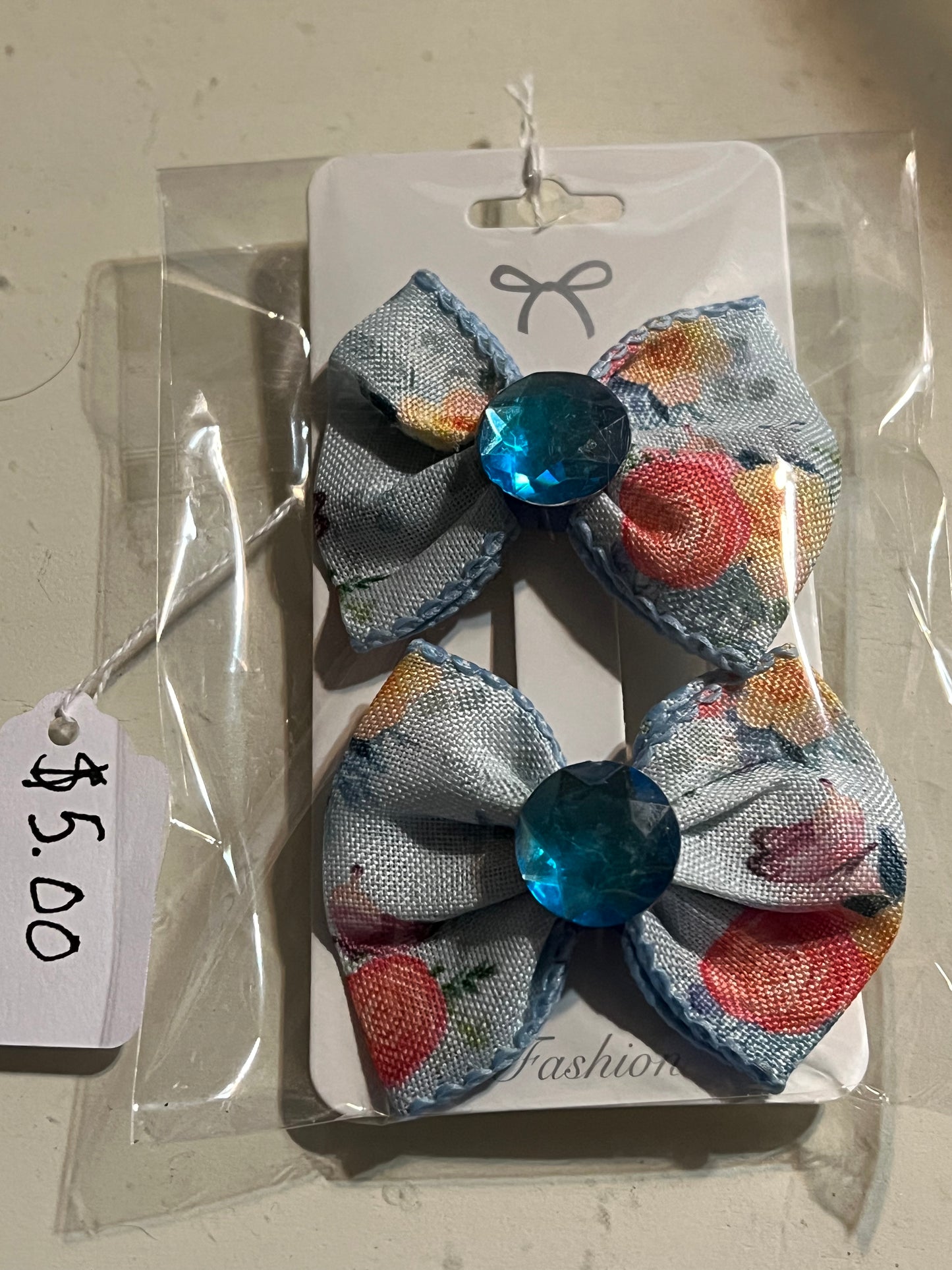 2 small blue hair bows