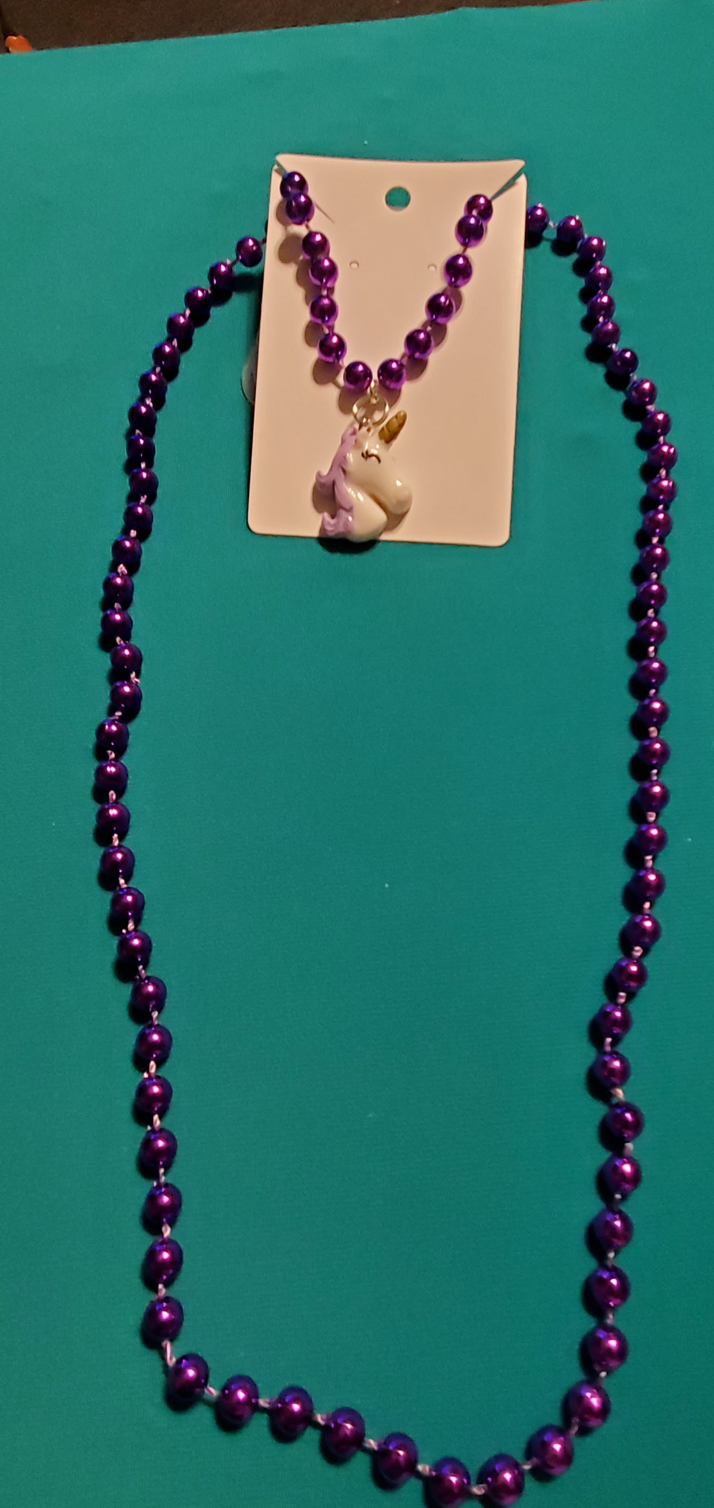 Purple and white unicorn on purple beaded necklace