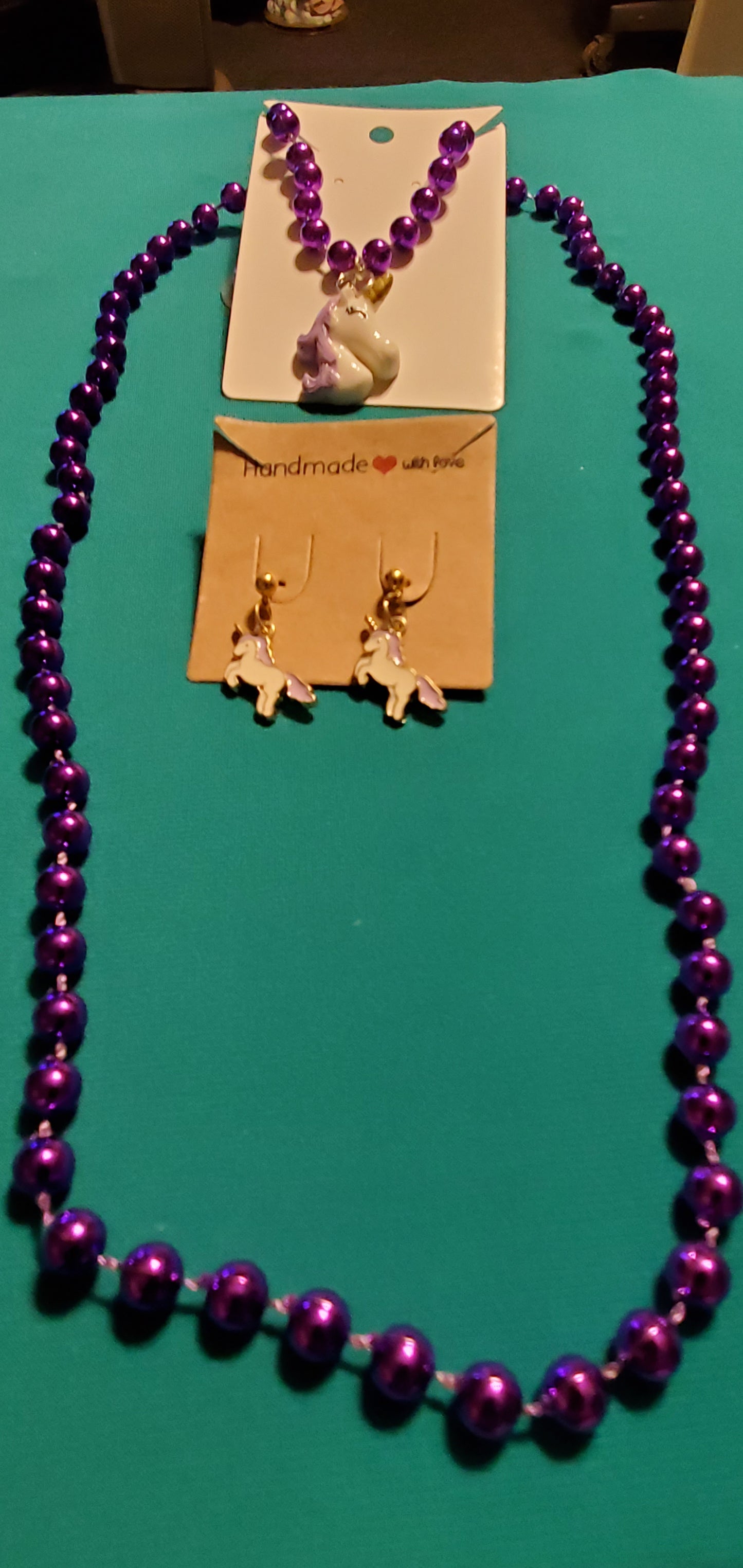 Purple and white unicorn on purple beaded necklace