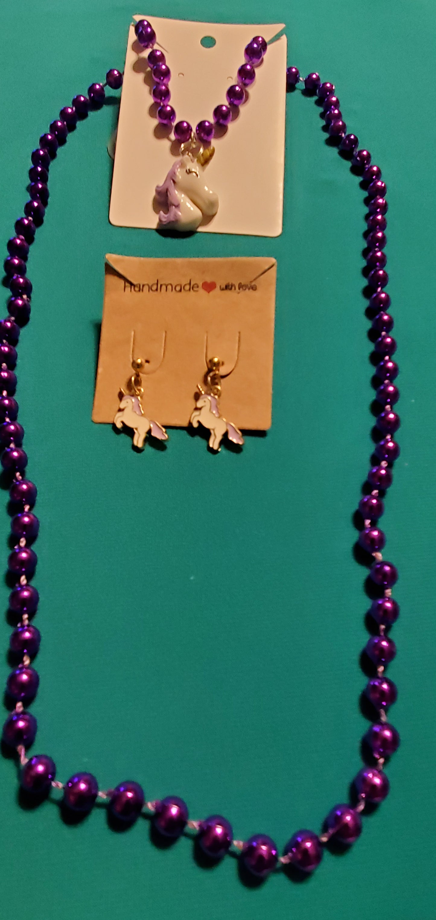 Purple and white unicorn on purple beaded necklace