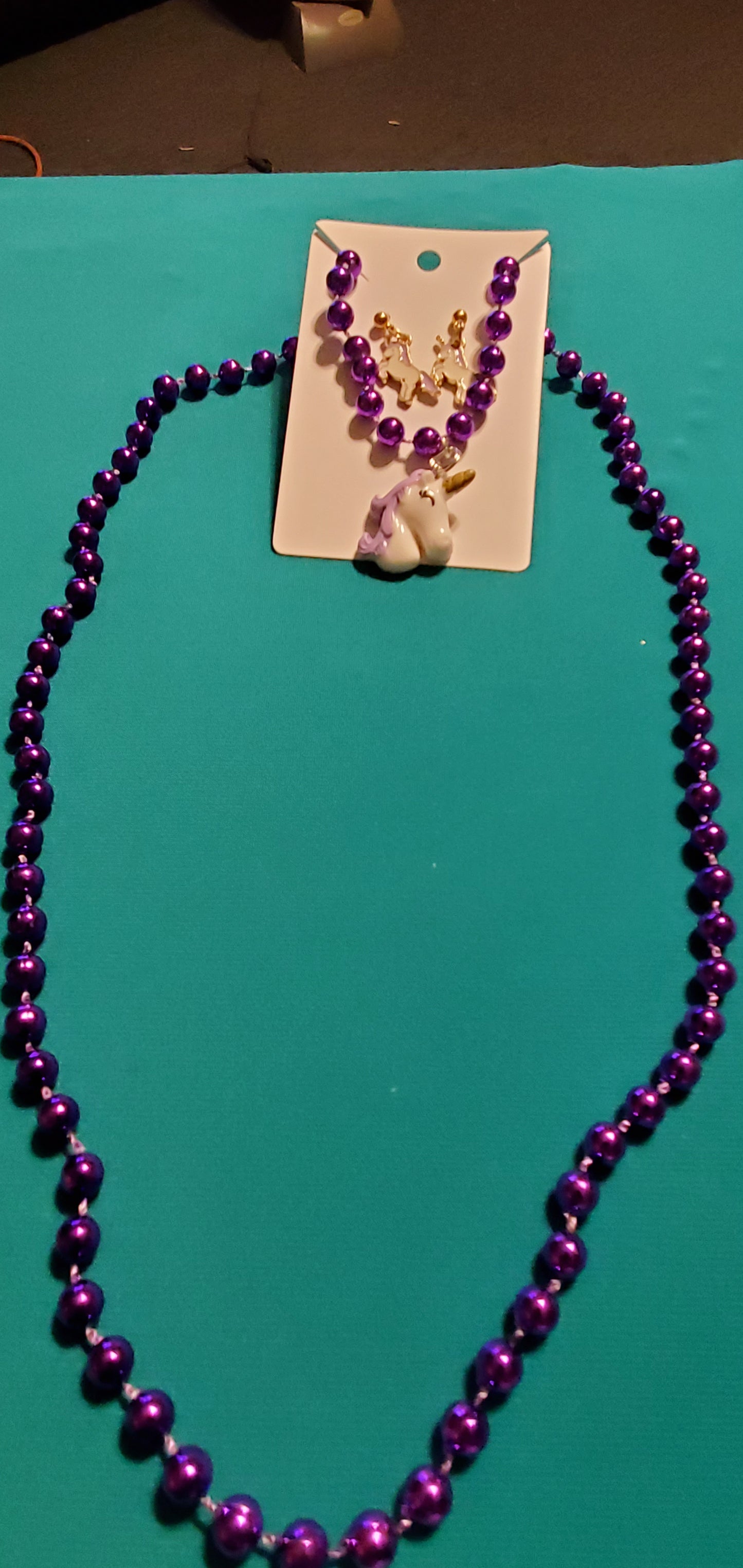 Purple and white unicorn on purple beaded necklace
