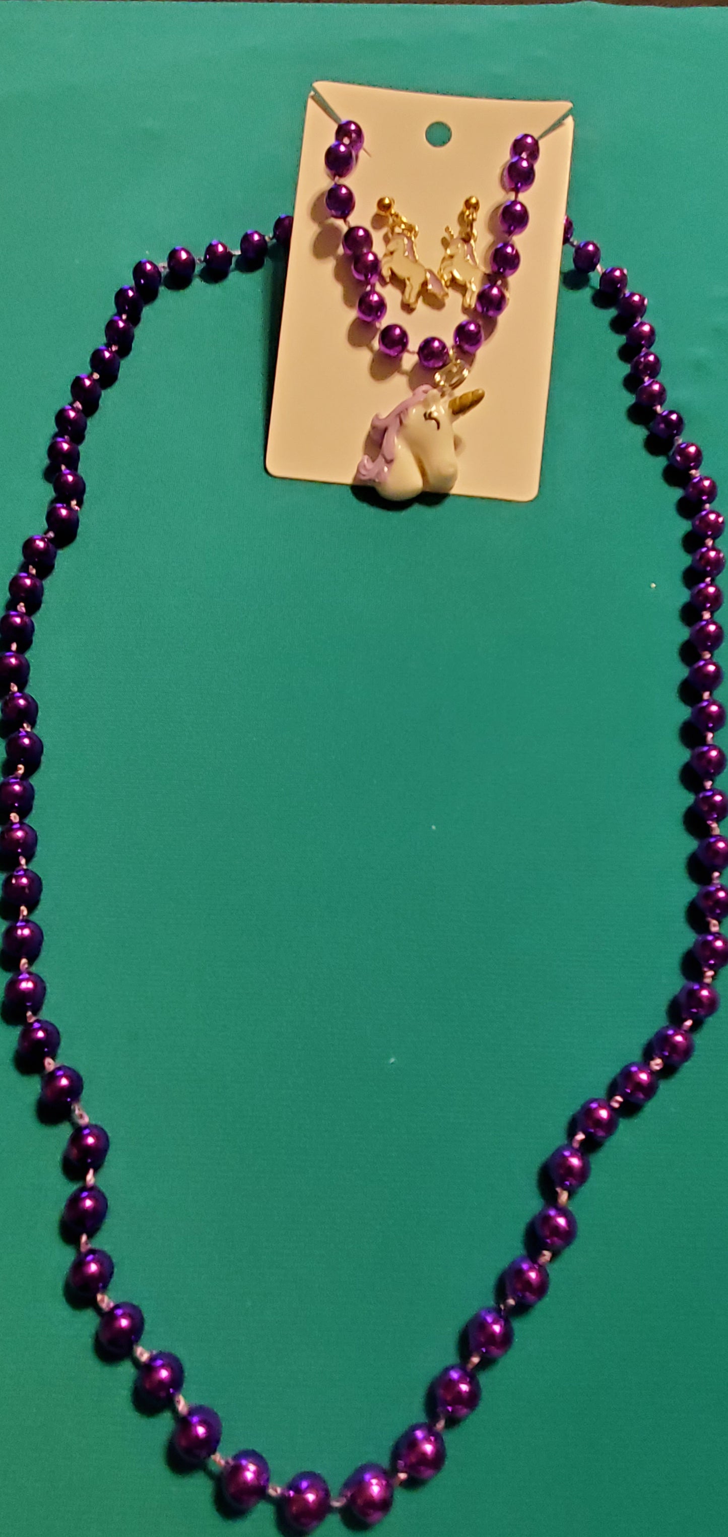 Purple and white unicorn on purple beaded necklace
