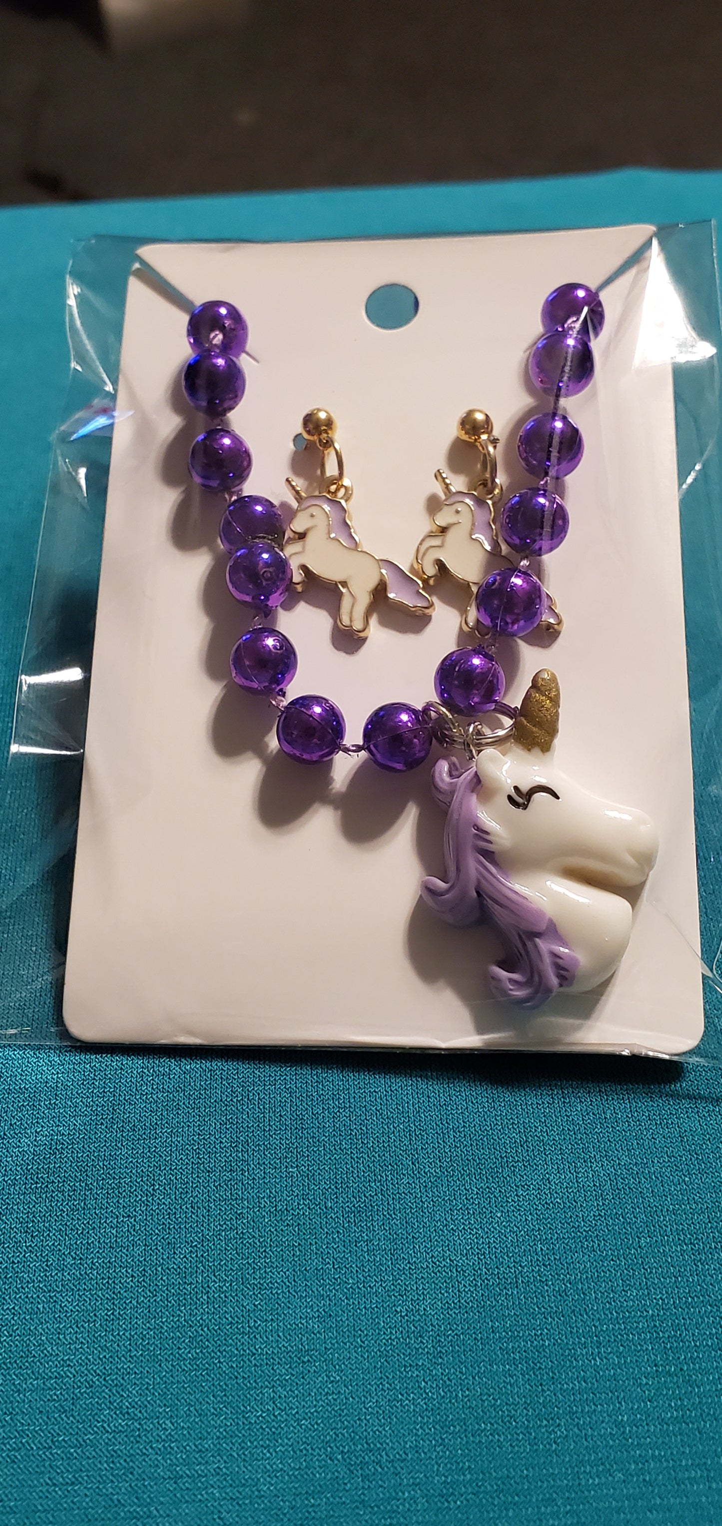 Purple and white unicorn on purple beaded necklace