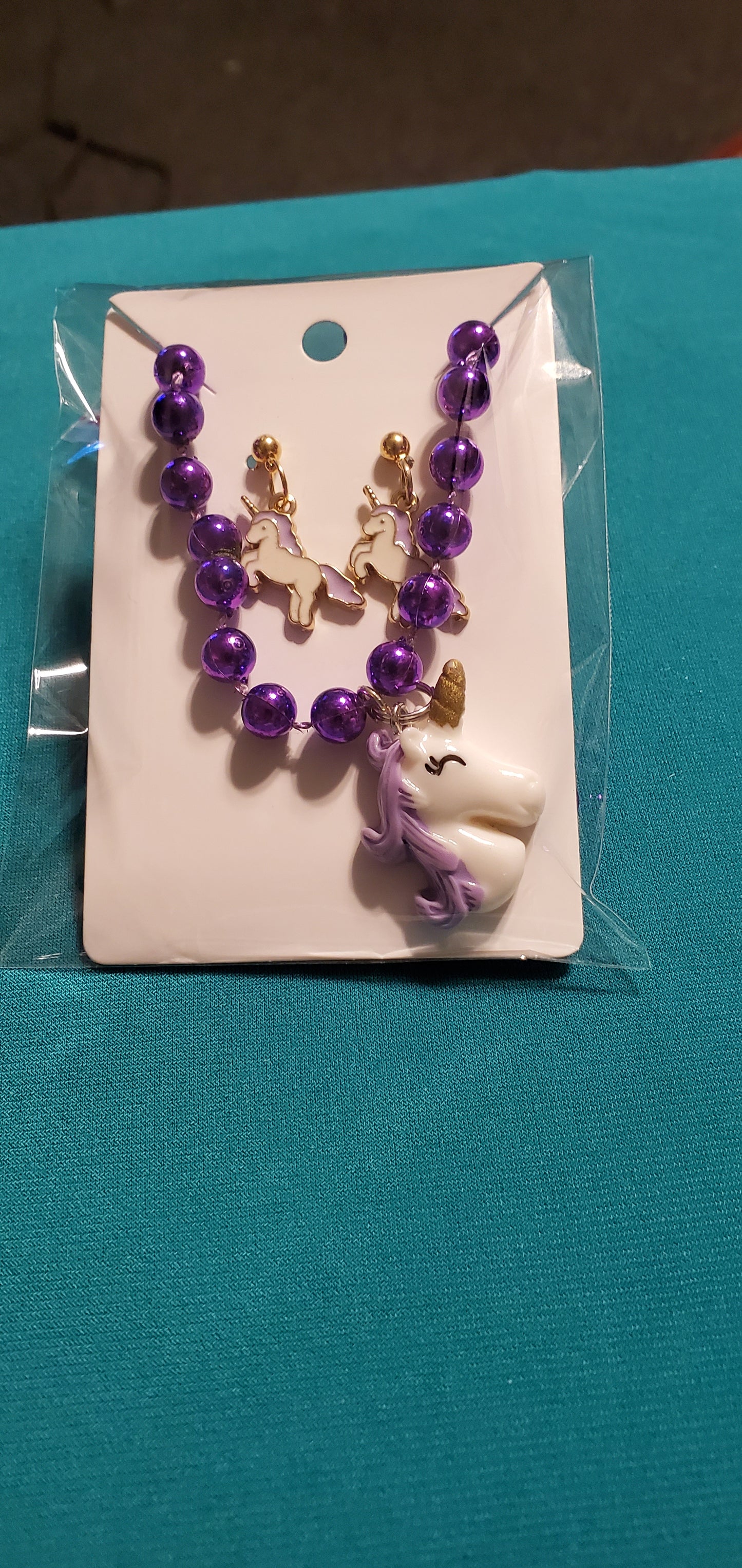 Purple and white unicorn on purple beaded necklace