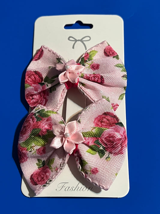 Light pink hair bow with light pink ribbon flower in the center.