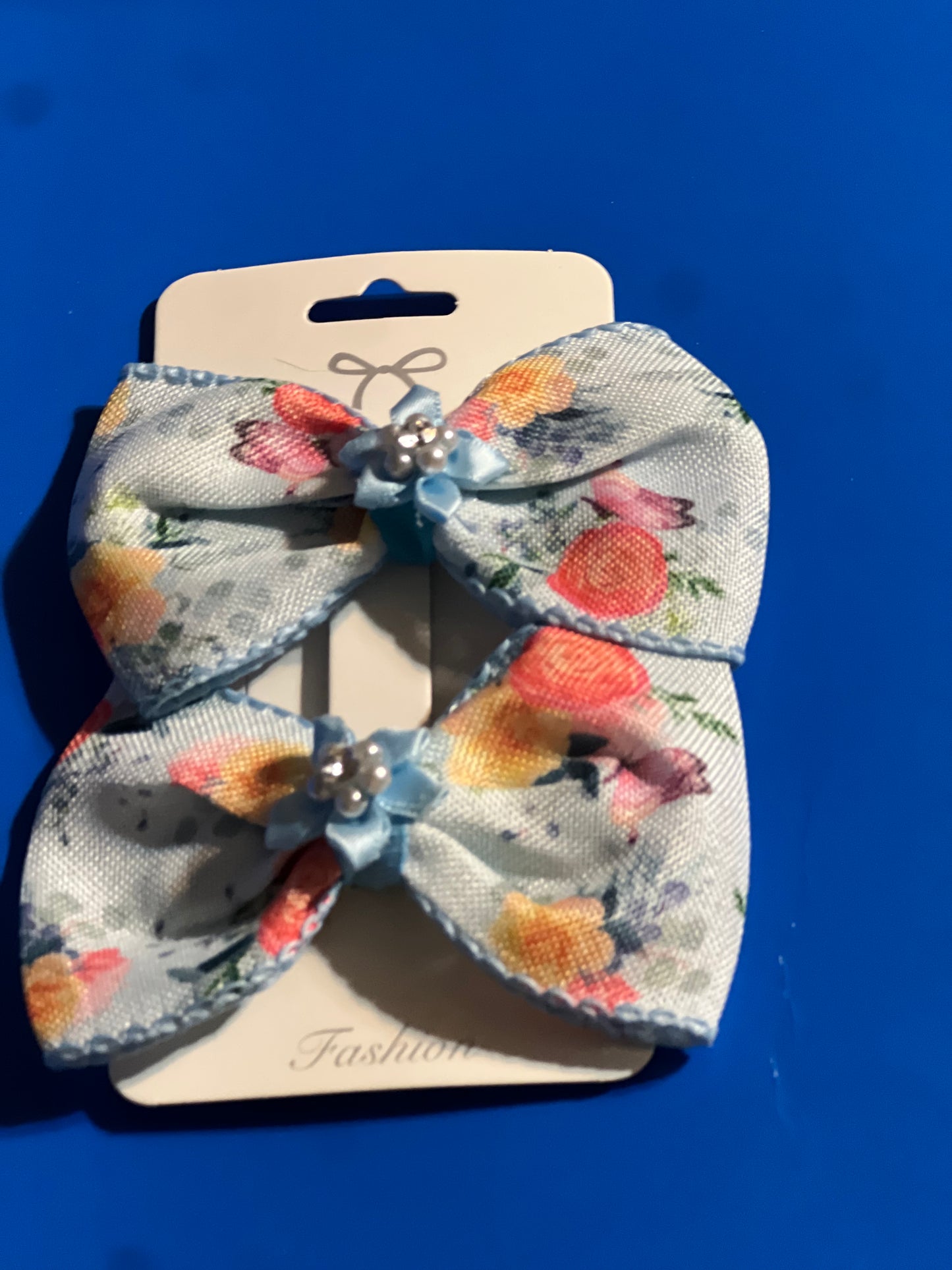 Blue flowerly hair bows with blue flower in the middle