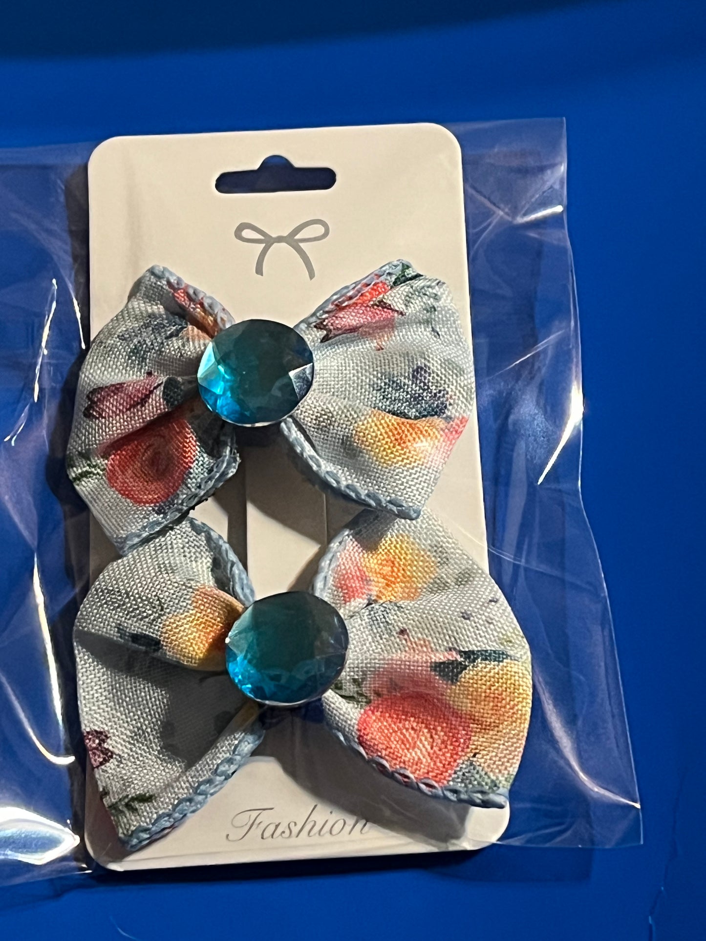 2 small blue hair bows